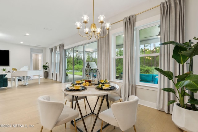 dining area with light hardwood / wood-style flooring and a chandelier