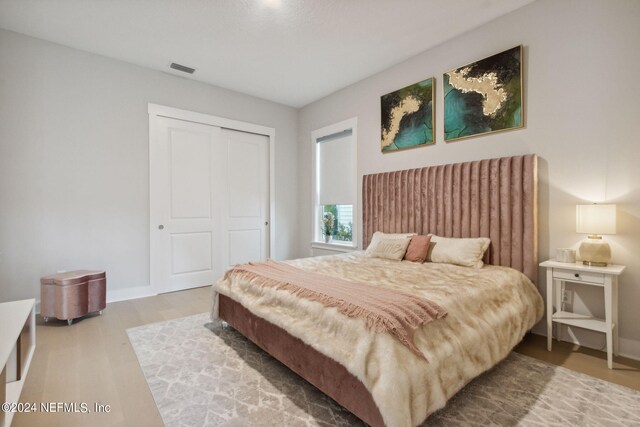 bedroom featuring a closet and hardwood / wood-style flooring