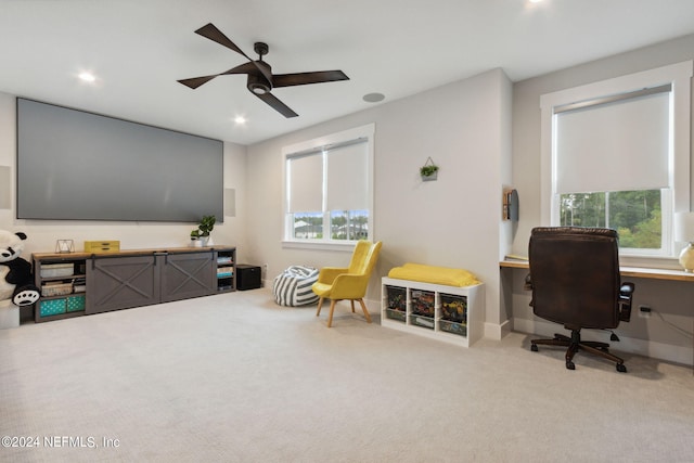 office featuring ceiling fan, light colored carpet, and a wealth of natural light