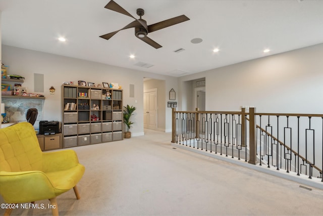 sitting room featuring ceiling fan and light colored carpet