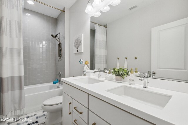 full bathroom featuring shower / bath combo, vanity, and toilet