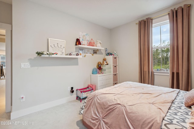 bedroom with carpet flooring and multiple windows