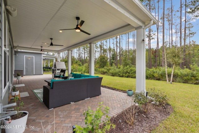 view of patio with an outdoor living space and ceiling fan