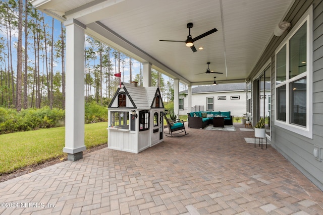 view of patio / terrace with an outdoor living space and ceiling fan