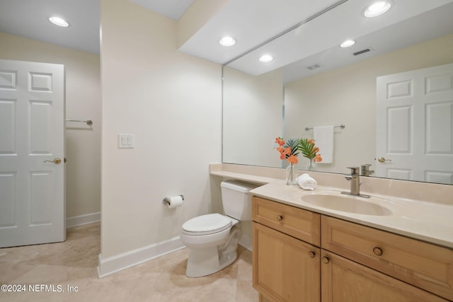 bathroom featuring vanity, tile patterned flooring, and toilet