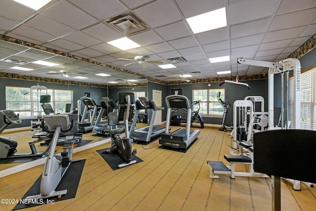 exercise room featuring a drop ceiling and ceiling fan