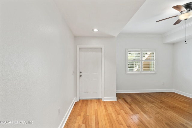 unfurnished room featuring ceiling fan, ornamental molding, and light hardwood / wood-style floors