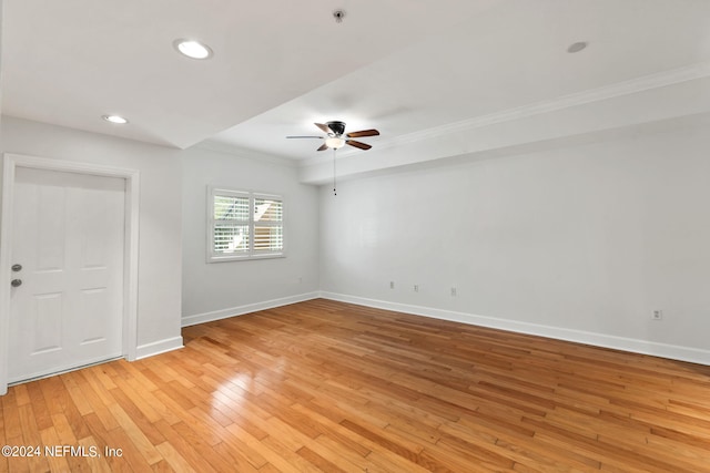 spare room with ceiling fan, crown molding, and light hardwood / wood-style floors