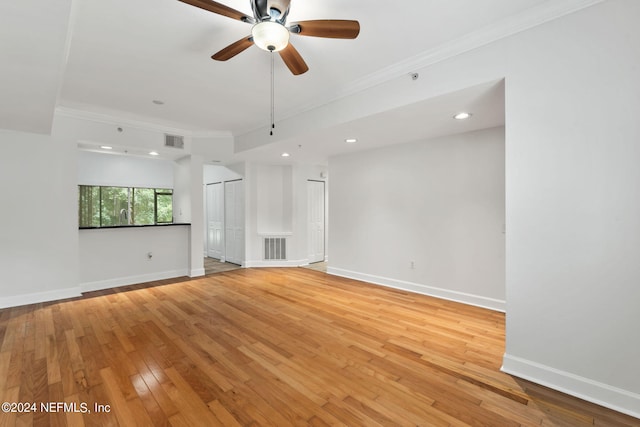 interior space with light hardwood / wood-style floors, ceiling fan, and crown molding