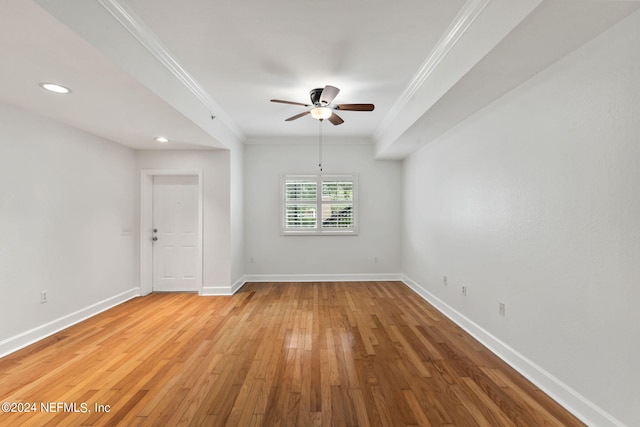 spare room with ceiling fan, crown molding, and hardwood / wood-style floors