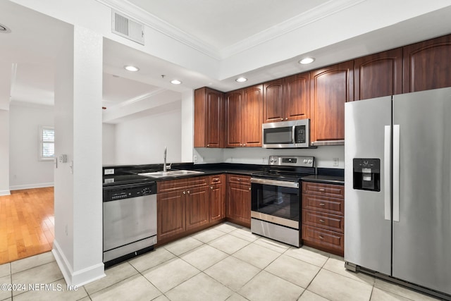 kitchen with stainless steel appliances, crown molding, light tile patterned floors, and sink