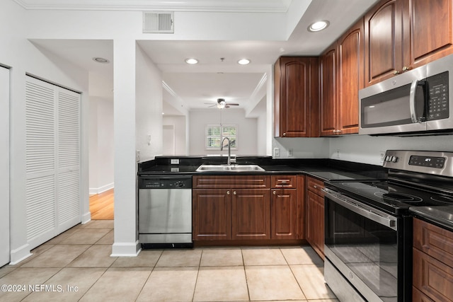 kitchen featuring appliances with stainless steel finishes, crown molding, light tile patterned flooring, and sink