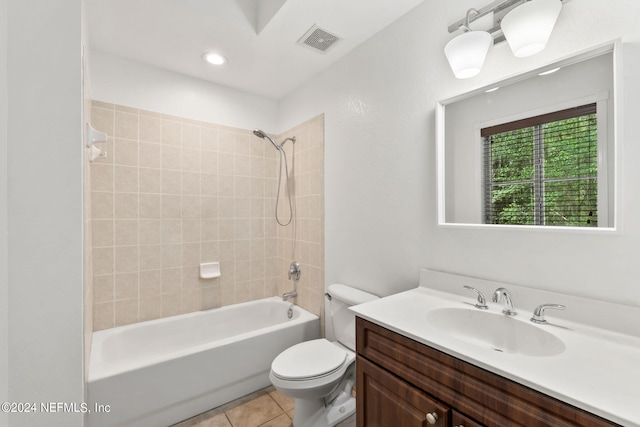 full bathroom with vanity, tile patterned floors, tiled shower / bath, and toilet