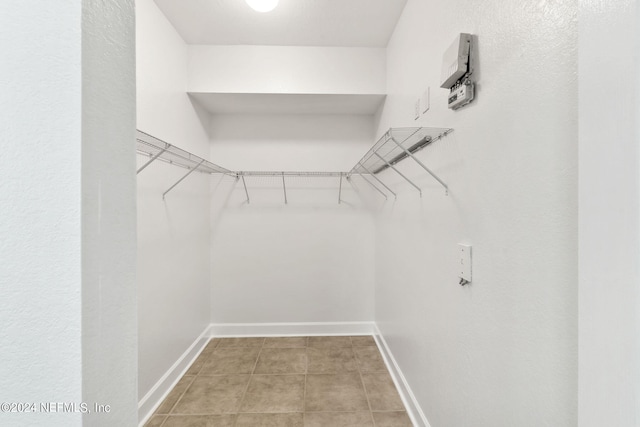 spacious closet with light tile patterned flooring