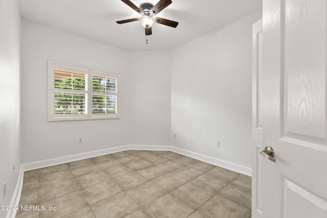 unfurnished room featuring light tile patterned flooring and ceiling fan