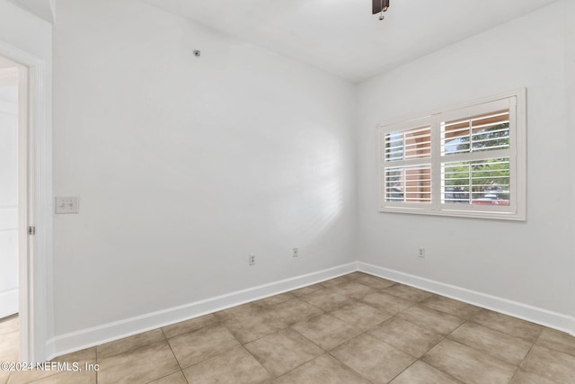 empty room featuring light tile patterned flooring and ceiling fan