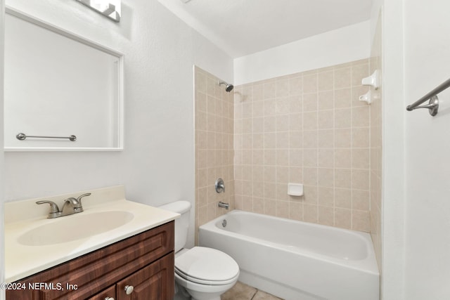 full bathroom featuring tile patterned flooring, tiled shower / bath, vanity, and toilet