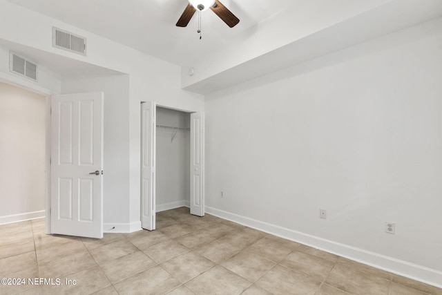 unfurnished bedroom featuring a closet, ceiling fan, and light tile patterned flooring