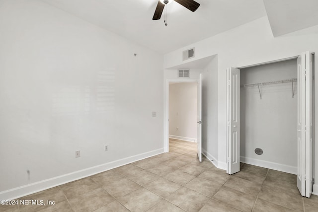 unfurnished bedroom with a closet, ceiling fan, and light tile patterned floors