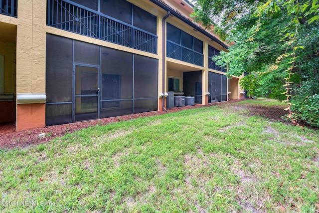 exterior space with a lawn and a sunroom