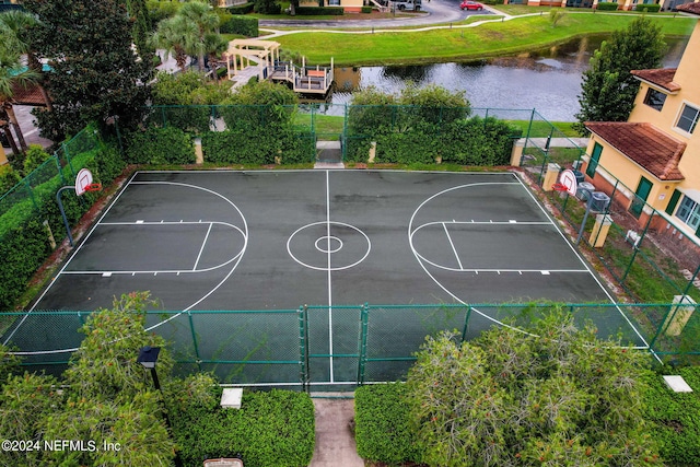 view of basketball court with a water view