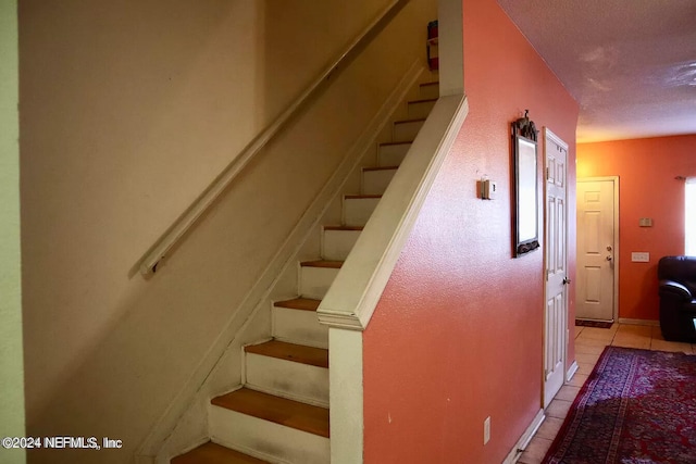 staircase with tile patterned floors