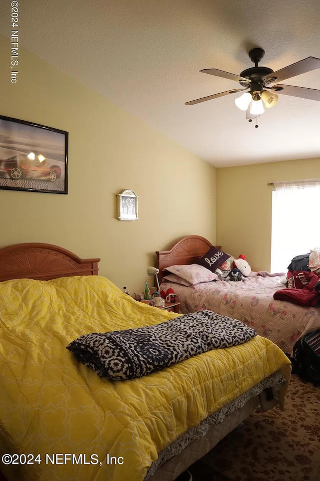 bedroom featuring ceiling fan and carpet