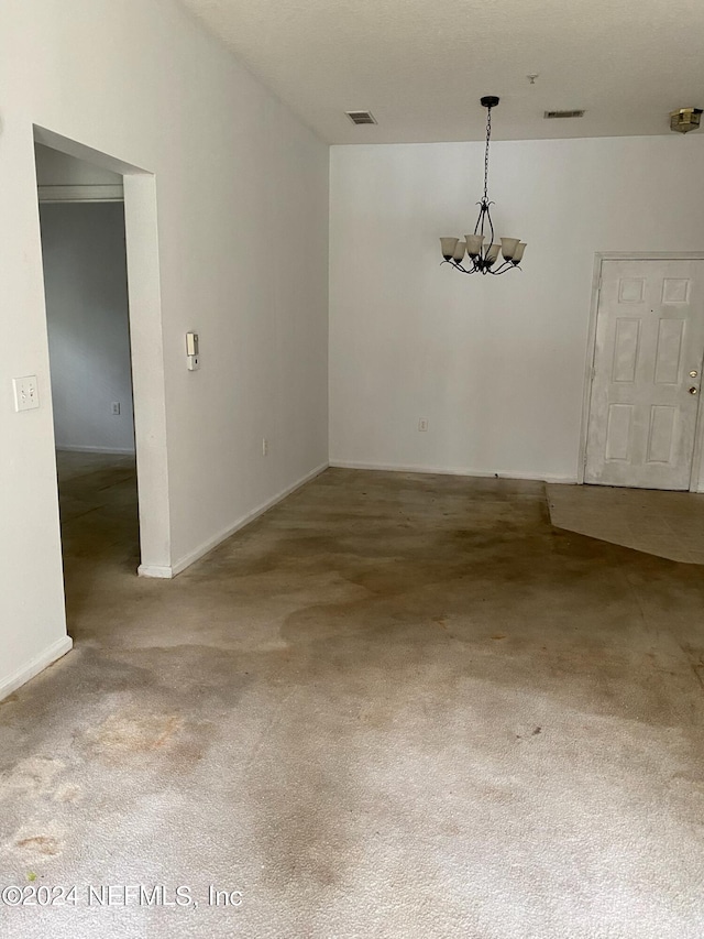 interior space with carpet floors and an inviting chandelier