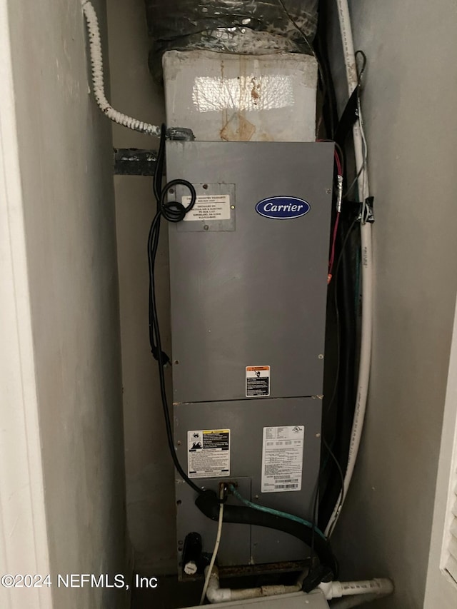 utility room featuring heating unit