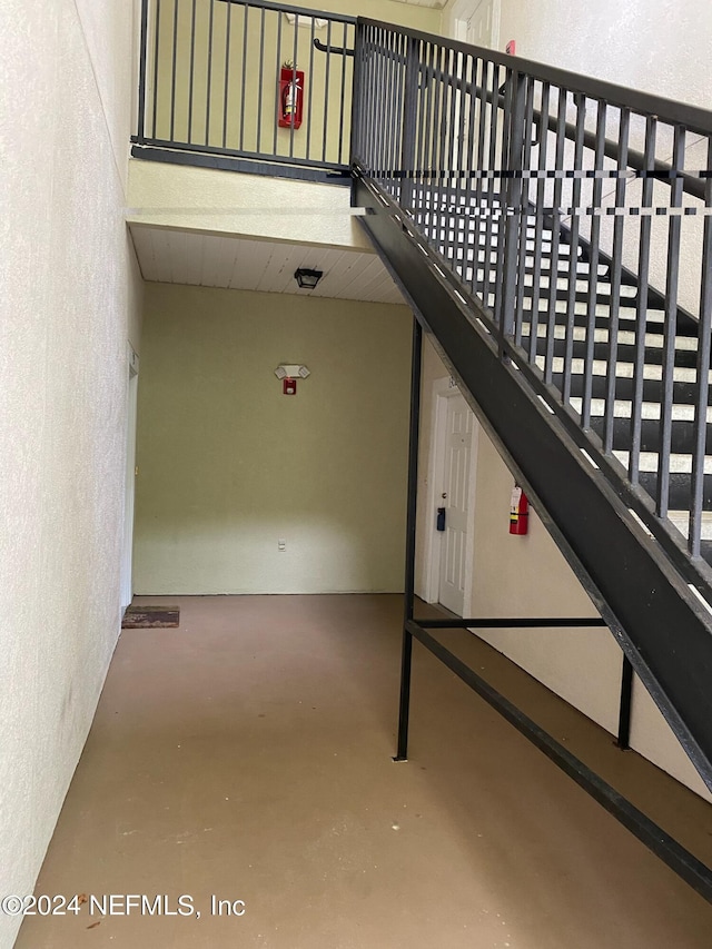 stairs with concrete flooring