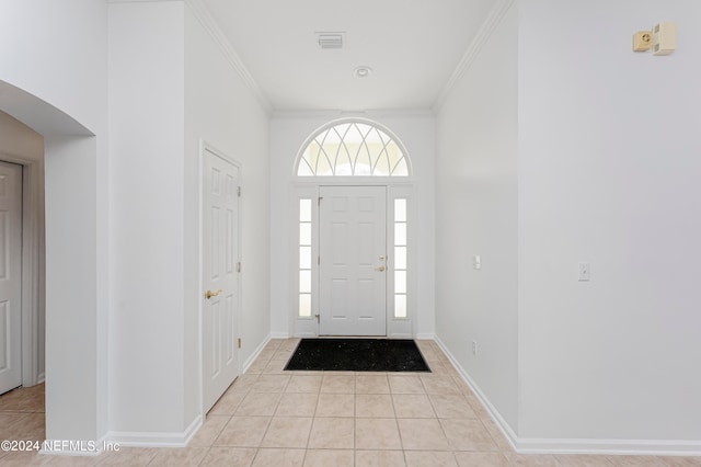 tiled foyer entrance featuring ornamental molding