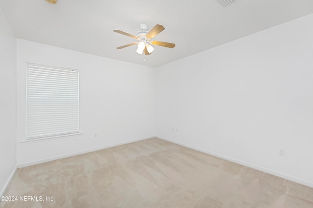 carpeted empty room featuring ceiling fan