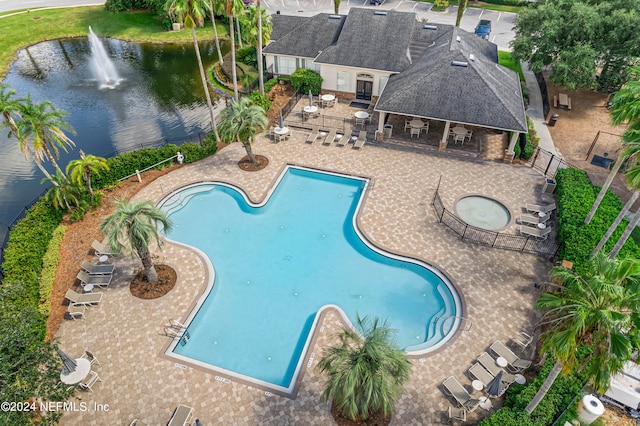 view of swimming pool with a patio and a water view