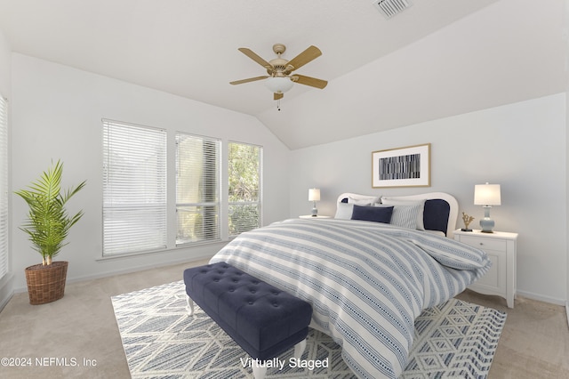 bedroom with ceiling fan, light carpet, and vaulted ceiling