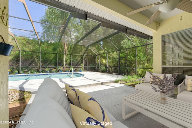 view of patio / terrace with an outdoor living space, glass enclosure, and ceiling fan