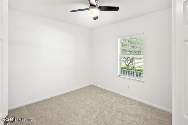 unfurnished room with ceiling fan and light carpet