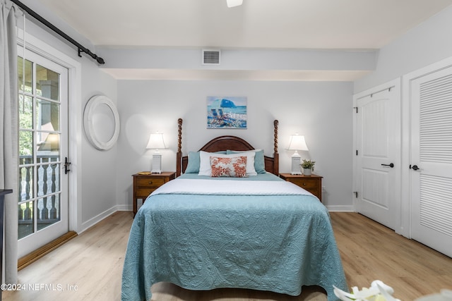 bedroom with a closet, light wood-type flooring, and access to exterior