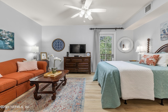 bedroom featuring access to outside, light hardwood / wood-style flooring, and ceiling fan