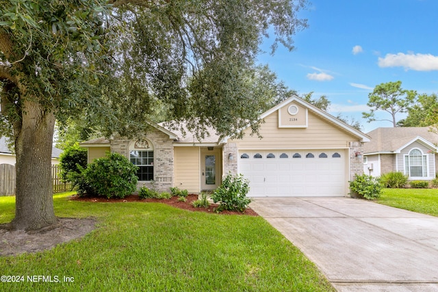 single story home featuring a front yard and a garage