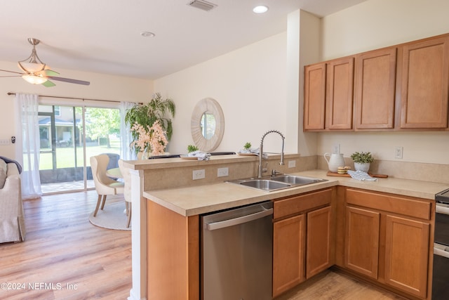 kitchen featuring light hardwood / wood-style floors, kitchen peninsula, sink, and stainless steel appliances