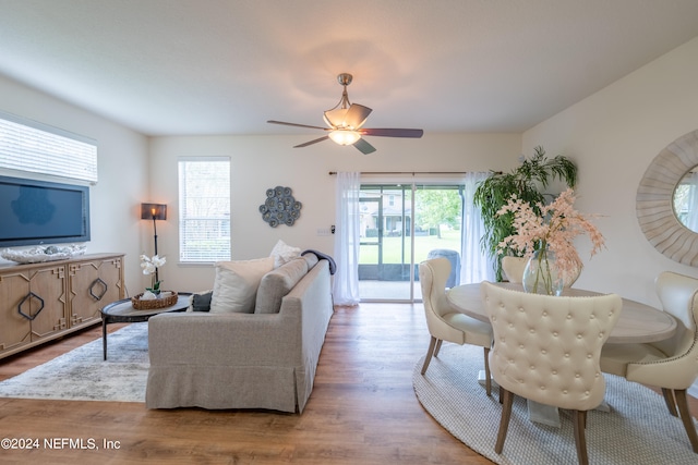 living room featuring light hardwood / wood-style flooring and ceiling fan