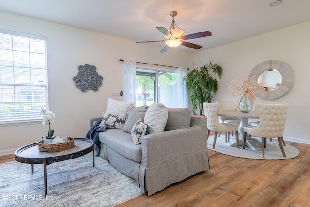 living room with ceiling fan, hardwood / wood-style flooring, and plenty of natural light