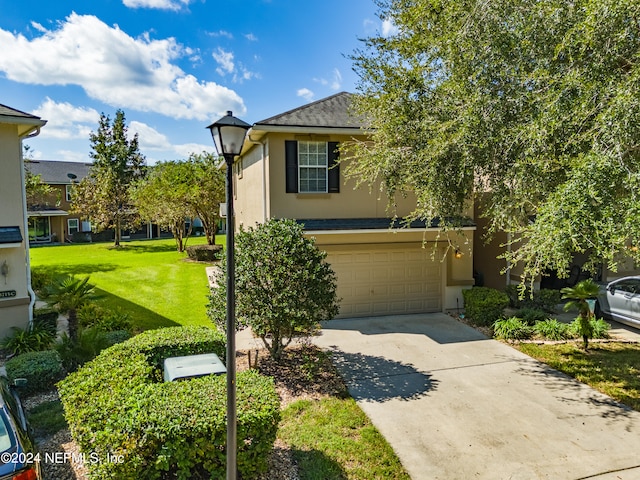 view of front of house with a garage and a front yard