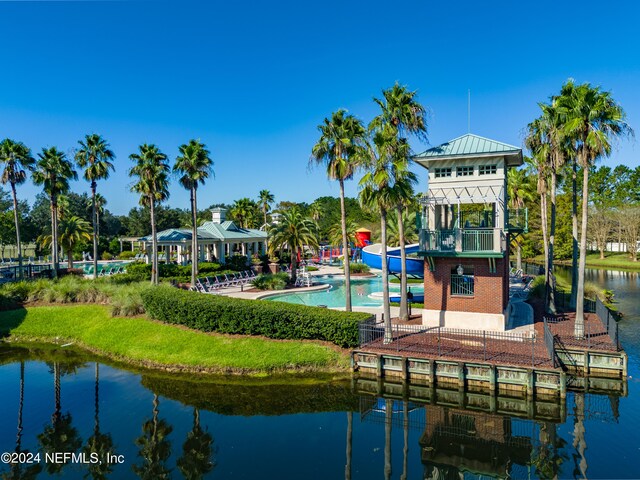 view of dock featuring a community pool, a patio area, a balcony, a gazebo, and a water view