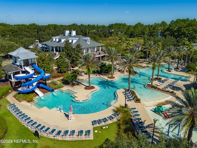 view of pool featuring a water slide and a patio area