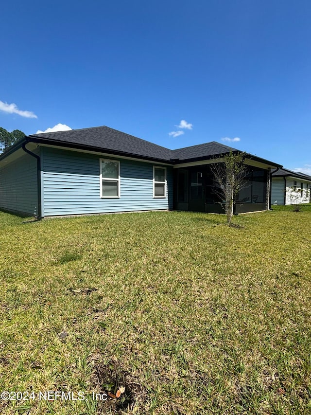 rear view of house with a yard