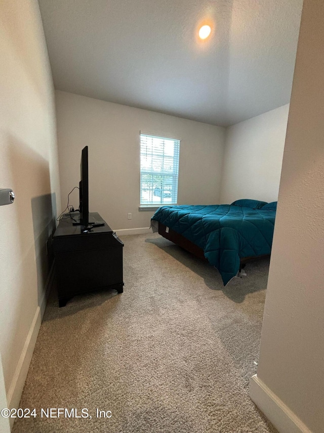 carpeted bedroom featuring a textured ceiling