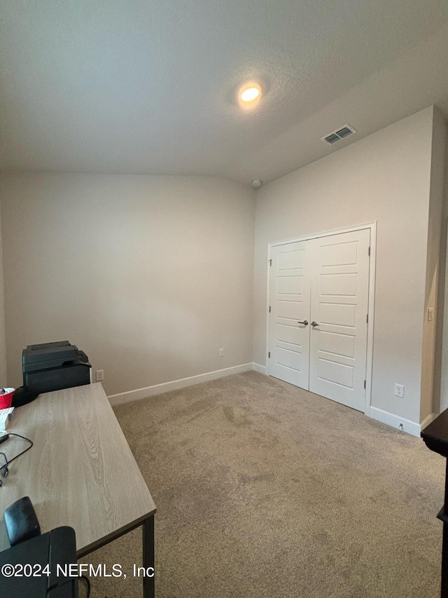 office area with a textured ceiling and carpet flooring