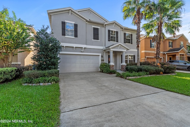 front facade with a front lawn and a garage