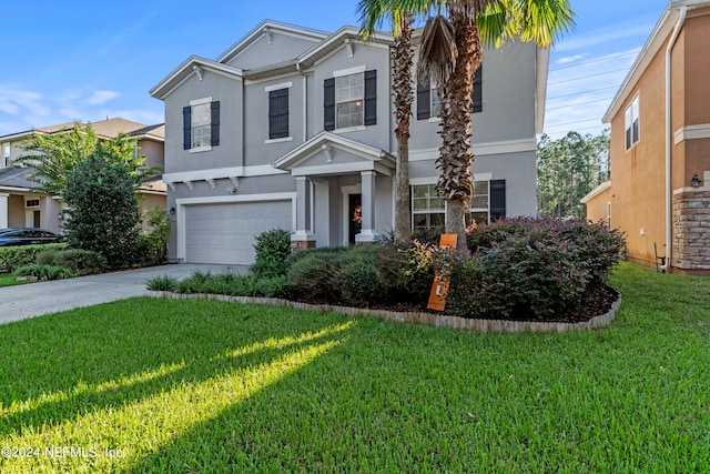 view of front of home with a front yard and a garage